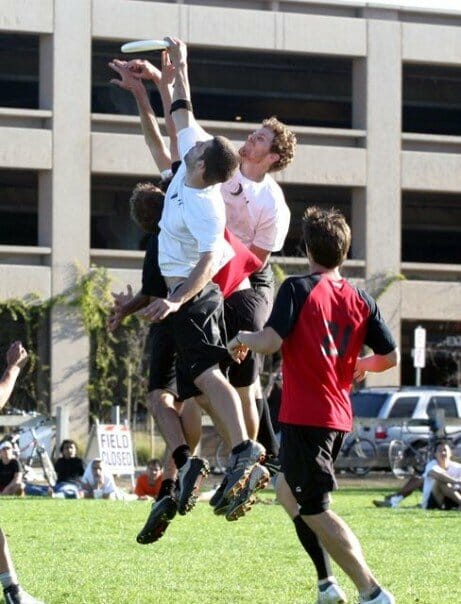 UNC Darkside Ultimate players jumping over defenders to catch the disc.