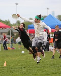 Oregon's Aaron Honn grabs the disc past a Georgia defender.