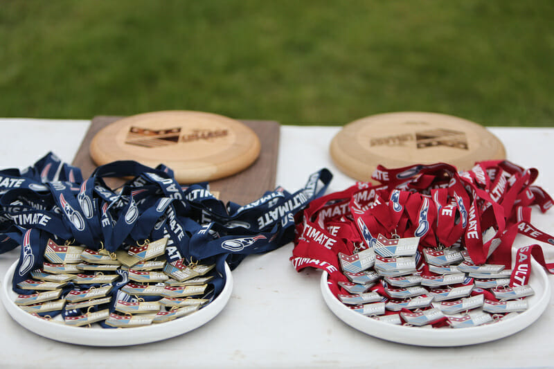 The gold and silver medals awarded to the Open Division at the 2013 USA Ultimate D-I College Championships.