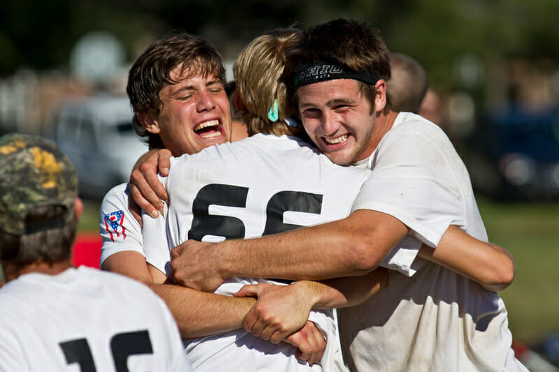Madcow teammates embrace after winning the game to go at Great Lakes Regionals