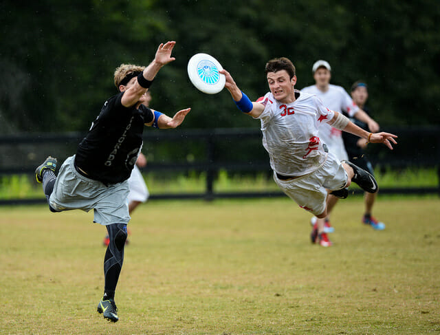A London Clapham player makes a huge grab past Boston Ironside's Brandon "Muffin" Malecek at the 2013 Chesapeake Invite. Photo: Kevin Leclaire -- UltiPhotos.com