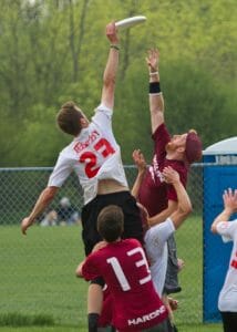 A Puget Sound player rises above the Harding defender at the 2013 D-III National Championships.