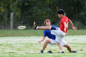 Two young players battle on the field.