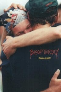 Mike hugs Stanford player Brandon Hyde after winning 2002 College Nationals