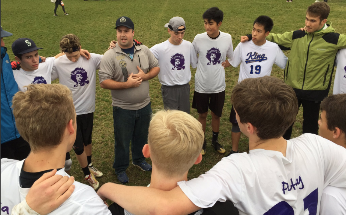 Garfield HS coach Rusty Brown talks to the team in the huddle.