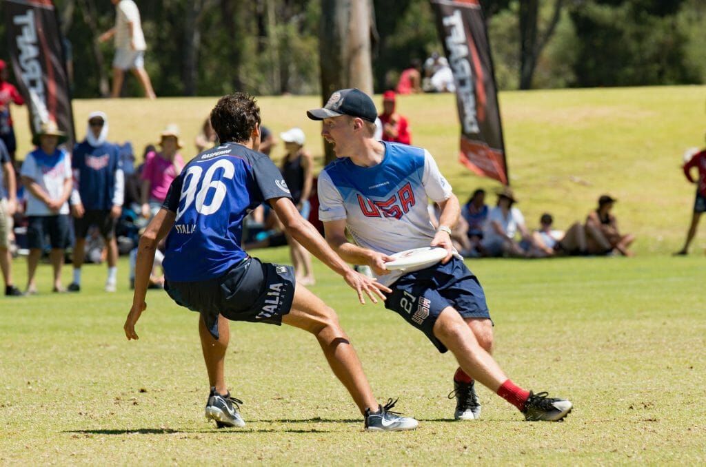 The United States' Codi Wood tries to get past Italy's Simone Gasperini at the WFDF U24 World Championships.