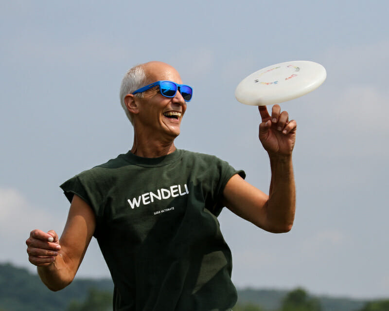 A parent at an ultimate tournament showing off their freestyle skills.