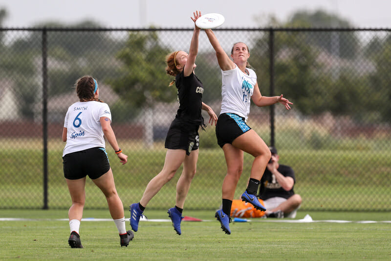 Colorado's Rachel Wilmoth goes up against a UCLA player in the air at the 2019 D-I College Championships.