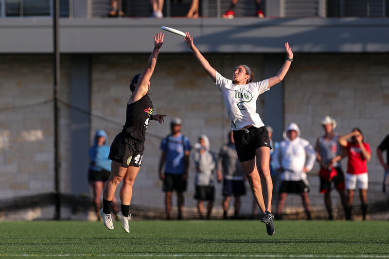 Wisconsin and Colorado players leap at the a disc at the 2019 D-I College Championships.