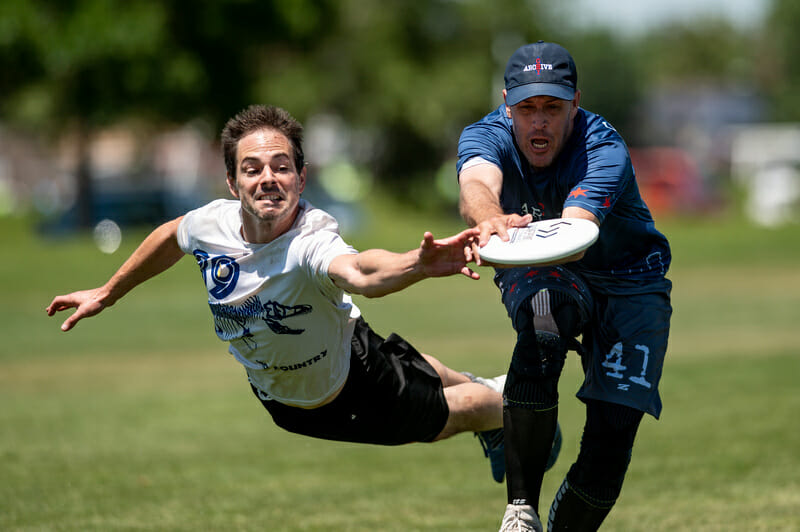 Burlington No Country goes for the block against Chicago Archive in the Grand Masters Men's division of the 2019 USAU Masters Championships. Photo: Sam Hotaling -- UltiPhotos.com 