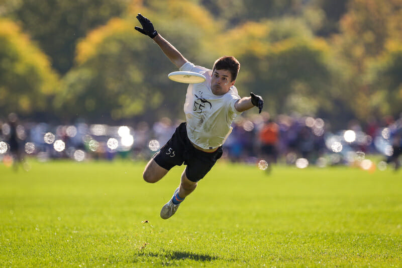 Boston Slow White's Ryan Cardinal soars toward a layout grab in the light of a perfect fall evening at New England Club Regionals. Photo: Paul Rutherford -- UltiPhotos.com