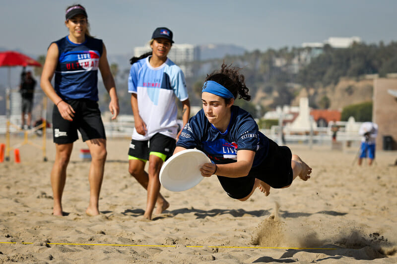 Anna Thompson makes the layout grab at the Beach of Dreams showcase game. Photo: Kristina Geddert -- UltiPhotos.com