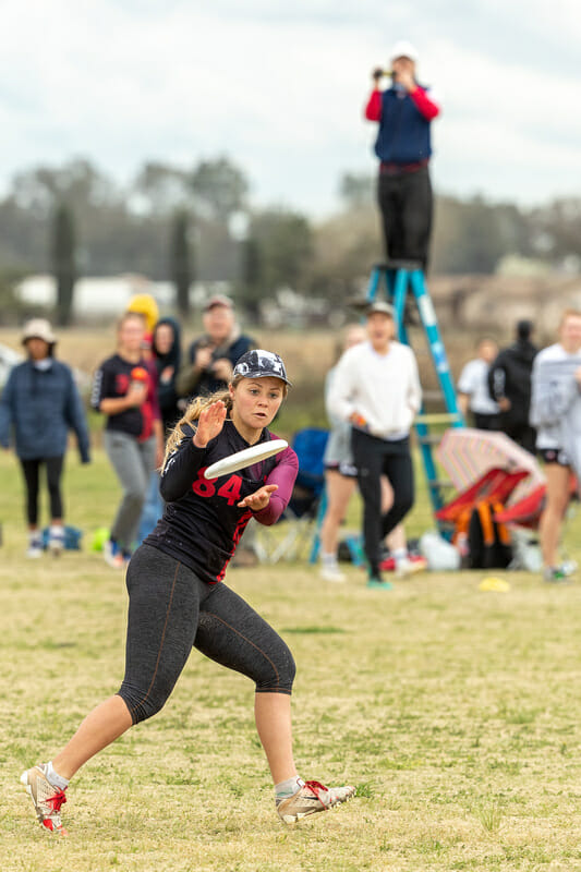 Hallie Dunham make a catch as her dad films in the background, atop his famous ladder. Photo: Rodney Chen -- UltiPhotos.com