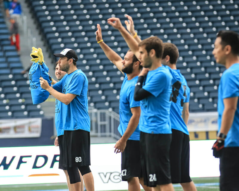 Albany All Bashed Out honoring their former teammate while awaiting the opening pull at the 2018 WMUCC Men's Masters final. Photo: Sandy Canetti -- UltiPhotos.com