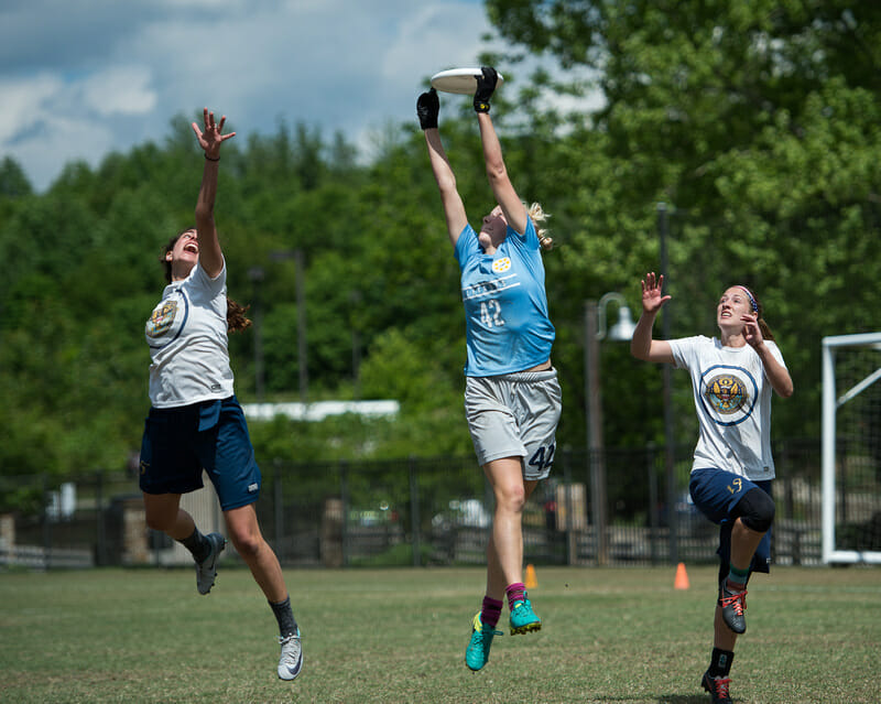 North Carolina's Rebecca Fagan makes a catch over two defenders at Atlantic Coast Regionals 2017.