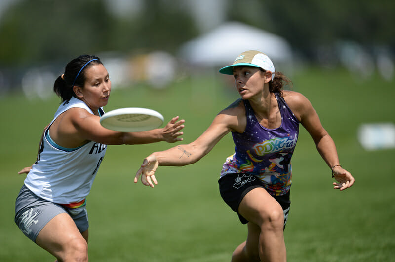 A PDXtra player gets off a throw around the mark set by a Reboot Squad players at the Masters Championships. Photo: Kevin Leclaire -- UltiPhotos.com