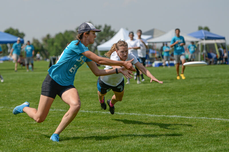 Alex Fussell scores despite the competitive defensive layout by Ashley Daly at the Masters Championships. Photo: Kevin Leclaire -- UltiPhotos.com
