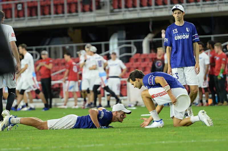 The Chicago Union's MVP-candidate handler, Pawel Janas, is offered a helping hand at their 2021 AUDL Championship Weekend semifinal.