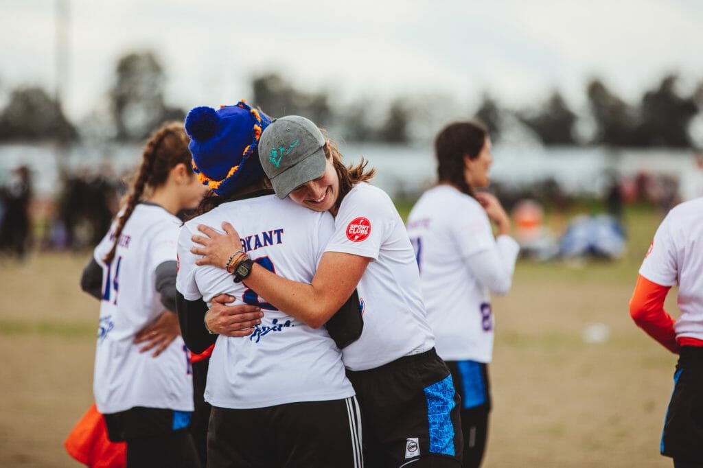 University of Florida college women's ultimate frisbee team members embrace. Photo: Natalie Bigman-Pimentel -- UltiPhotos.com