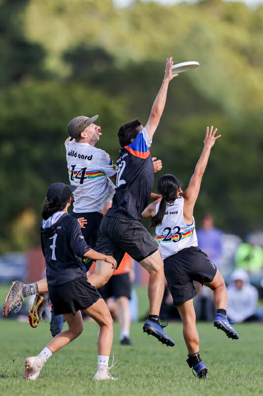 New York XIST wins the disc while being sandwich between two Wild Card players at 2021 Northeast Mixed Club Regionals. Photo: Alec Zabrecky — UltiPhotos.com