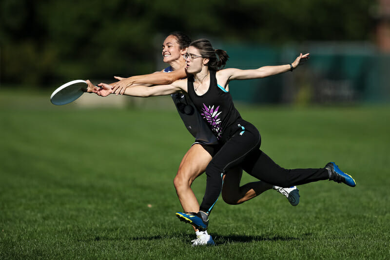 The disc is just an arm’s length away for both players at 2021 East New England Women's Sectionals. Photo: Burt Granofsky — UltiPhotos.com