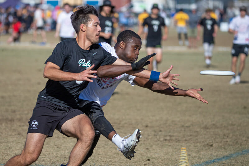 Azeez Adeyemi gets the block for Brown in the quarterfinals of the 2021 College Championships. Photo: Rodney Chen -- UltiPhotos.com