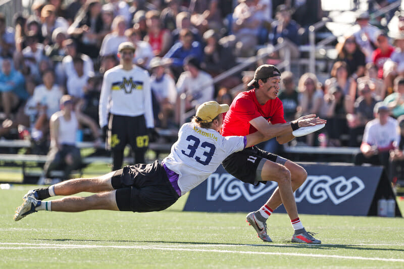 Michigan's James Hill's bid can't stop Georgia's Matt Cook from making the catch in a semifinal at the 2021 D-I College Championships in Norco, CA.