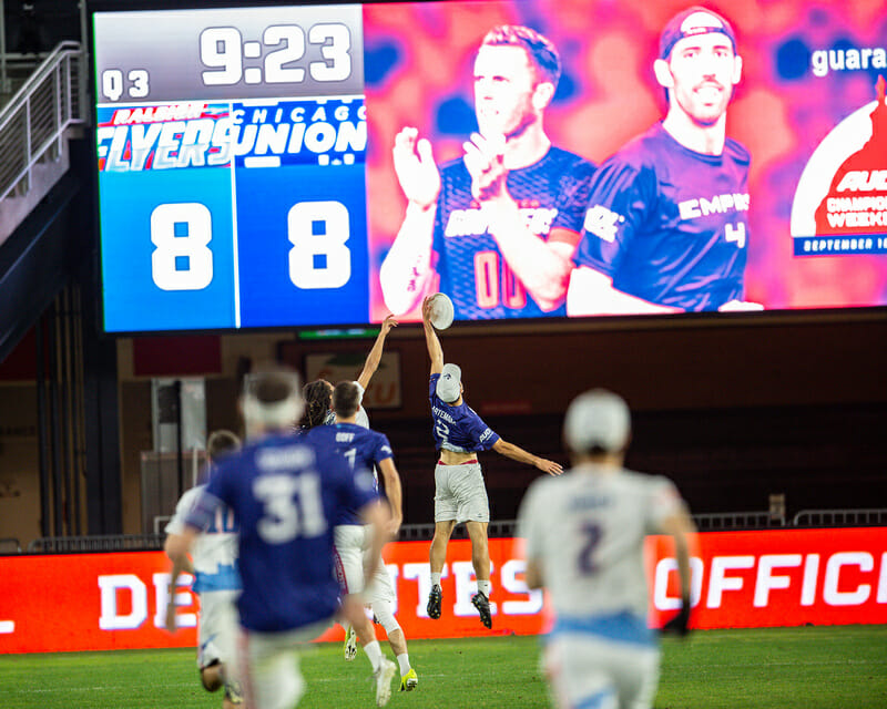 Raleigh and Chicago battle in front of the scoreboard at the 2021 AUDL Championship Weekend.