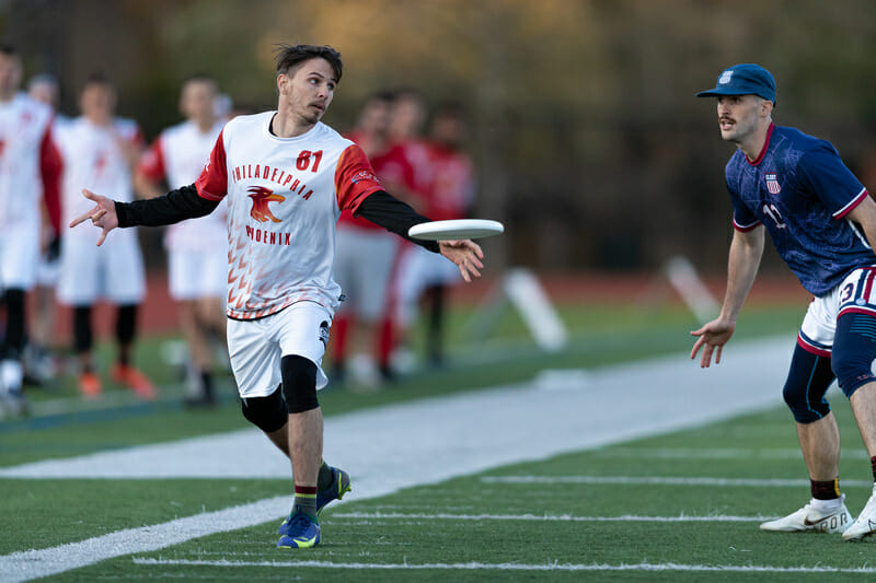 Phoenix' Sean Mott throws against Boston Glory's defense during Week 1 of the 2022 AUDL regular season.