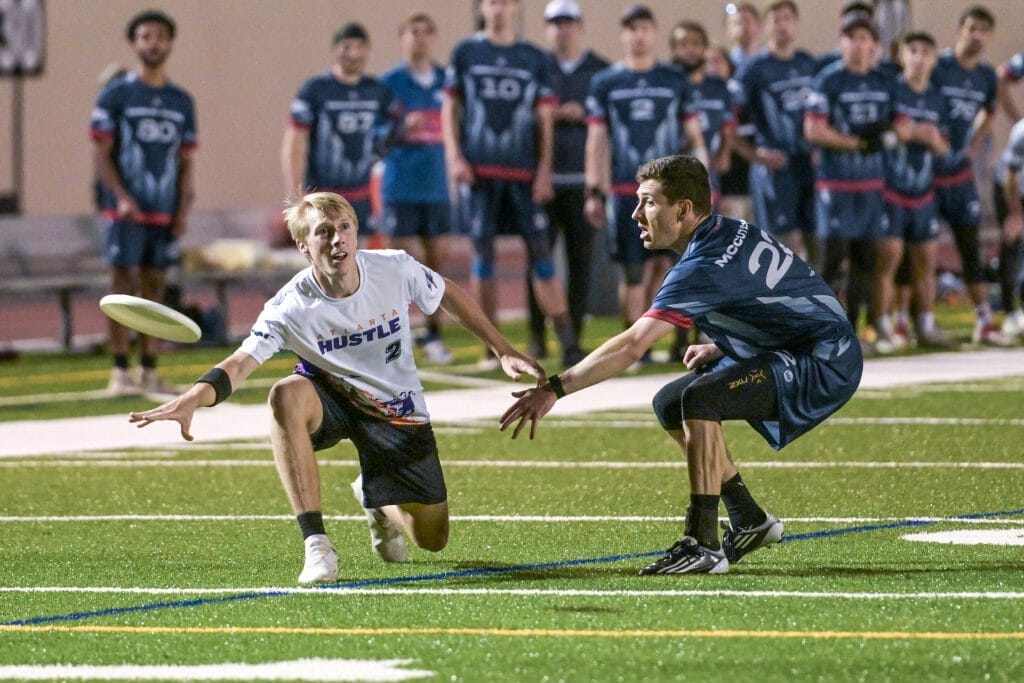 Atlanta Hustle's Austin Taylor throws past Carolina Flyers' Charlie McCutcheon during the 2022 AUDL regular season.