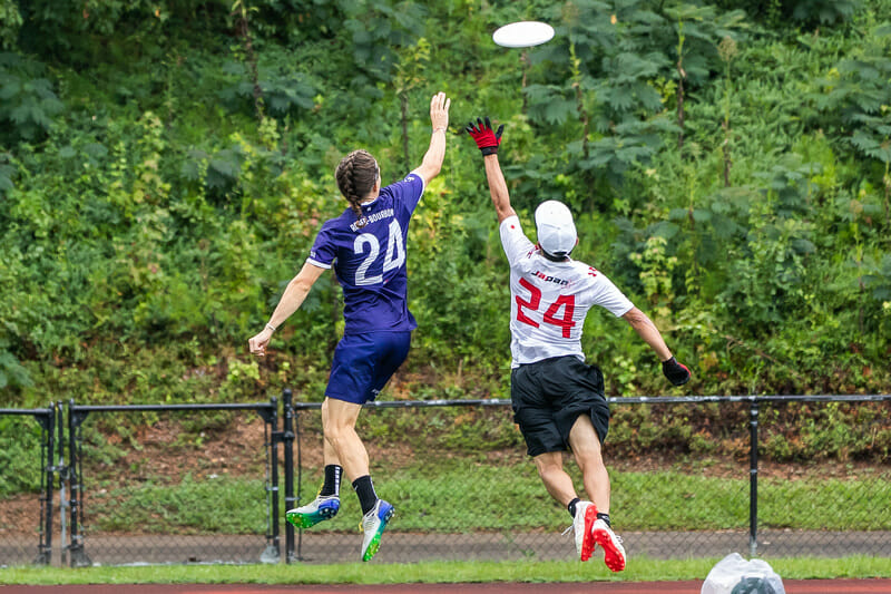 France's Quentin Roger and Japan's Taiyo Arakawa go up for a disc at the 2022 World Games.
