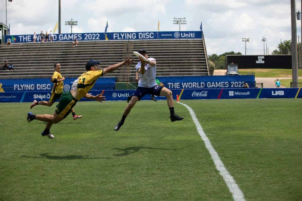 Australia's Alex Ladomatos just misses on a block in front of France's Sacha Poitte-Sokolsky in the opening round game for both teams at the 2022 World Games. Photo: Katie Cooper -- UltiPhotos.com