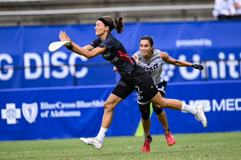 Germany's Nici Prien warps the disc with a block in their pool play win against the United States at the 2022 World Games. 