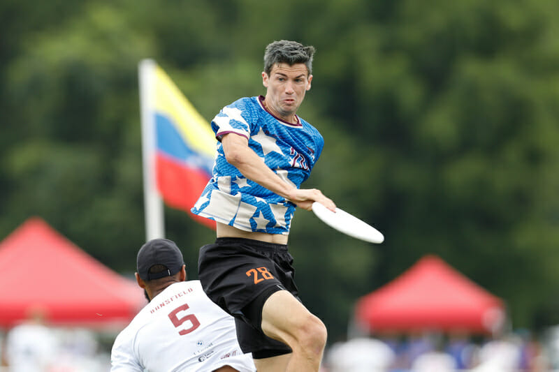 Ring of Fire's Jack Williams makes the grab against Mooncatchers in the WUCC 2022 semifinals. Photo: Marshall Lian -- UltiPhotos.com