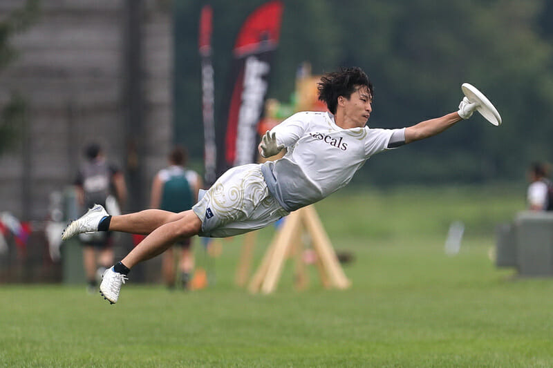 A player from Rascals flies through the air at the 2022 WUCC.