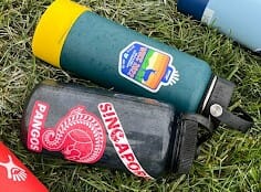 A Pangolin player's water bottle boasts colorful team stickers.