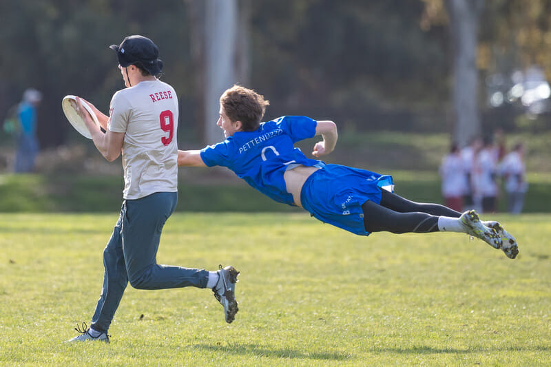 Victoria's Pettenuzzo's full extension comes up just short of the block against Santa Clara's Liam Reese at the 2023 Stanford Invite. Photo: Rodney Chen - UltiPhotos.com