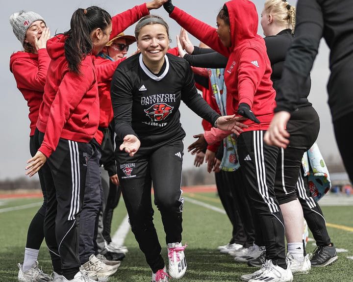 Davenport's Avery Smith runs through the spirit tunnel. Photo: Davenport Women’s Ultimate Frisbee team