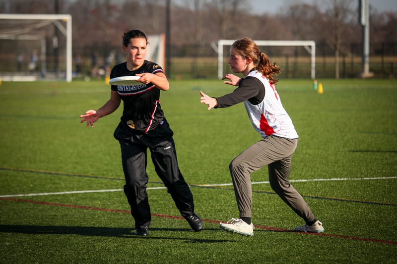 The Northeastern Valkyries throw a backhand against UPenn at the D-I Women's College Ultimate Frisbee Tournament, the East Coast Invite 2024. Photo: Diana Huang - UltiPhotos.com