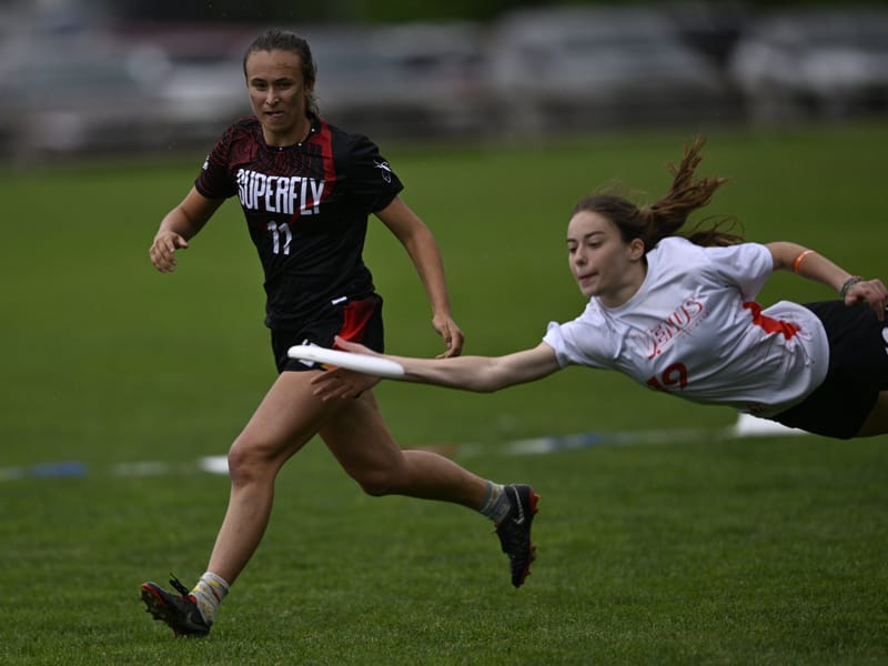 UPenn's Grace Maroon goes full extension to deny Stanford the disc at the 2024 D-I College Championships. Photo: Brian Canniff - UltiPhotos.com