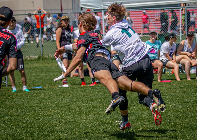 Davenport soar for the layout block in their universe point game against Lewis & Clark at the 2024 D-III men's College ultimate frisbee Championships. Photo: Rudy Desort - UltiPhotos.com